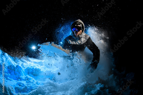 Man freerider doing stunts on blue light background