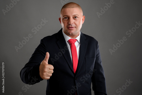 Businessman showing thumbs up