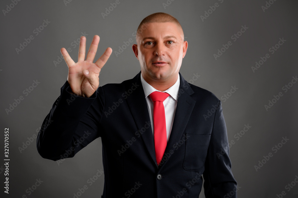 Businessman showing number four Businessman showing number four
