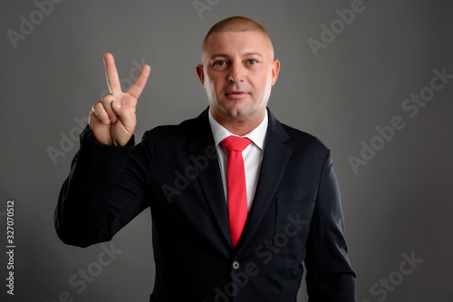 Businessman showing number two