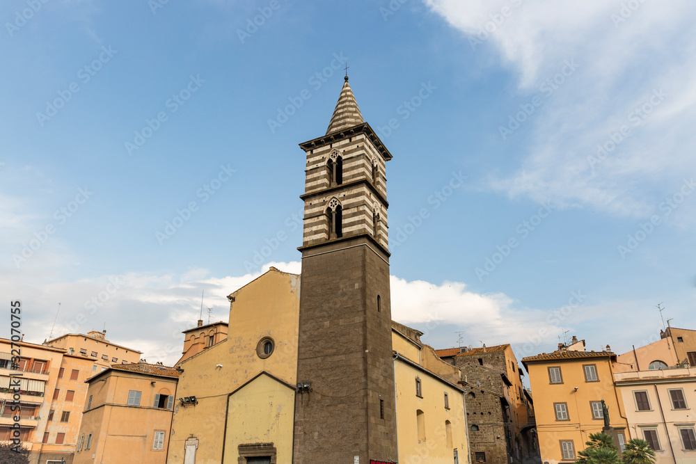 The bell-tower of San Giovanni Battista degli Almadiani church in Piazza dei Caduti square, Viterbo city, Lazio, Italy