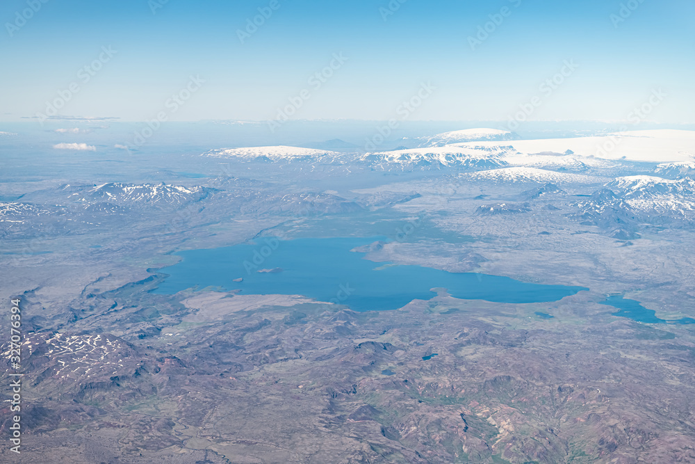 Iceland bird's eye aerial high angle view of Thingvallavatn rift valley lake from airplane window above and snowcapped mountains Iceland bird's eye aerial high angle view of Thingvallavatn rift valley lake from airplane window above and snowcapped mountains