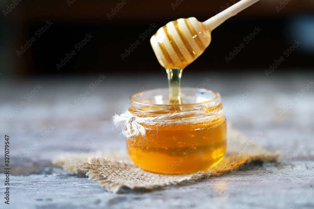 Honey in a jar. Stick for honey. Healthy sweetness. Beekeeping product. Honey in a jar. Stick for honey. Healthy sweetness. Beekeeping product.