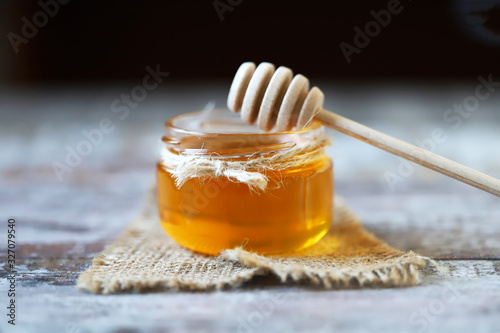 Honey in a jar. Stick for honey. Healthy sweetness. Beekeeping product.