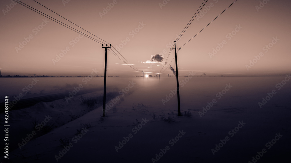 Winter dawn in the fields and electricity lines running forward. Winter dawn in the fields and electricity lines running forward.