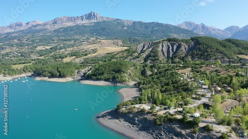 Serene summer landscape of Lake Serre-Poncon, artificial lake surrounded by French Alps, Provence-Alpes-Cote d Azur region photo