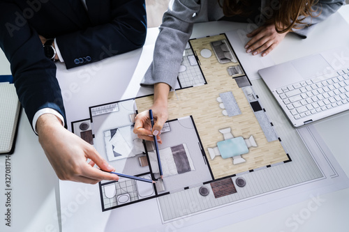 Photos Two Architects Discussing Blueprint