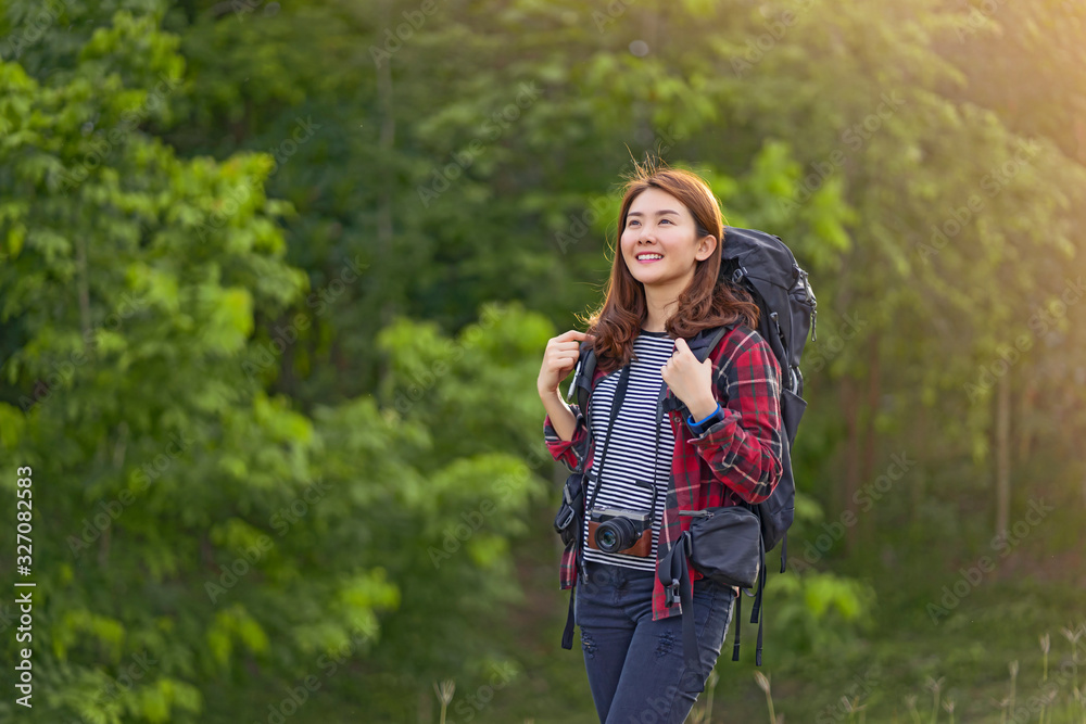 Asian woman traveler with backpack looking at amazing mountains river wanderlust and forest, Traveling tropical travel concept, copy space for text, see the beautiful natural landscape in Thailand Asian woman traveler with backpack looking at amazing mountains river wanderlust and forest, Traveling tropical travel concept, copy space for text, see the beautiful natural landscape in Thailand
