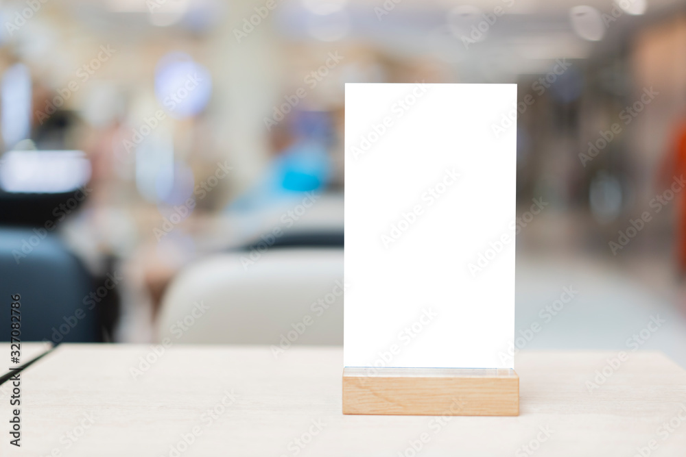 Mock up Label the blank menu frame in Bar restaurant ,Stand for booklets with white sheets paper acrylic tent card on wooden table cafeteria blurred background can inserting the text of the customer. Mock up Label the blank menu frame in Bar restaurant ,Stand for booklets with white sheets paper acrylic tent card on wooden table cafeteria blurred background can inserting the text of the customer.