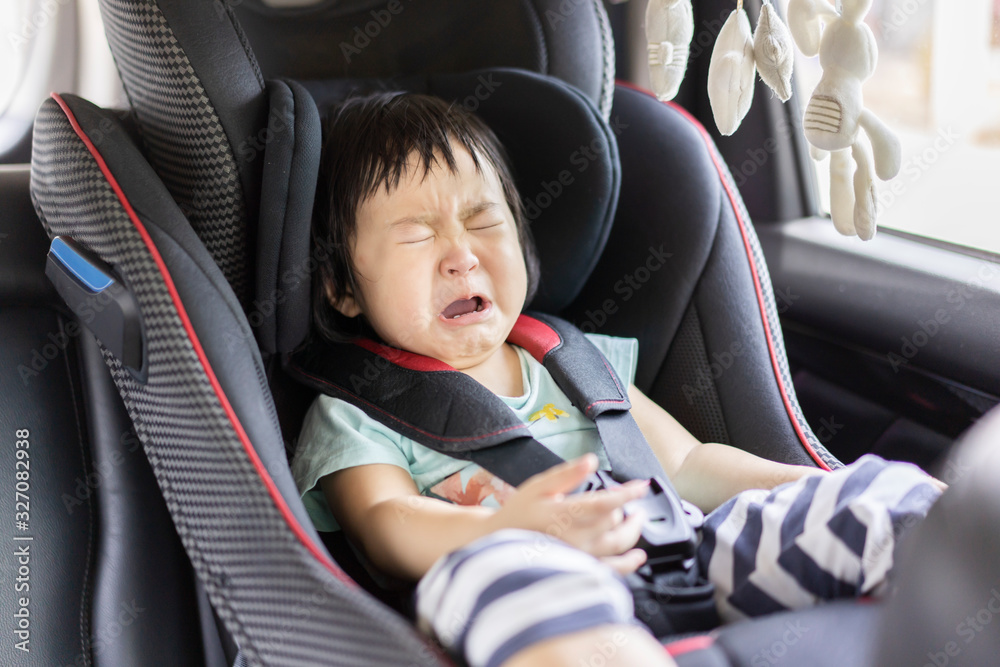 Foto de Asain baby crying little girl on the car seat in the car before