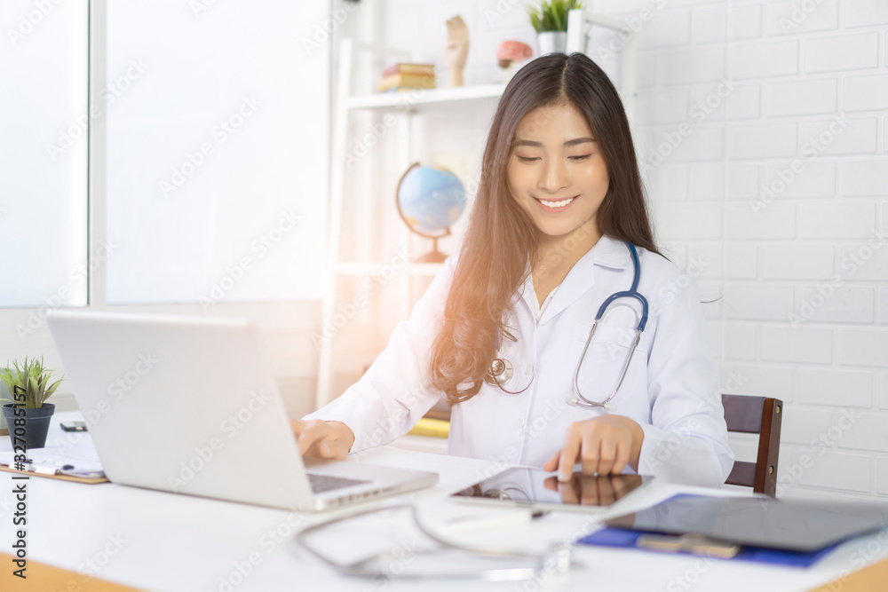 Medical technology network team meeting concept. Asian Doctor working with smartphone modern digital tablet and laptop computer with graphics chart interface result of an examination of her patients Medical technology network team meeting concept. Asian Doctor working with smartphone modern digital tablet and laptop computer with graphics chart interface result of an examination of her patients