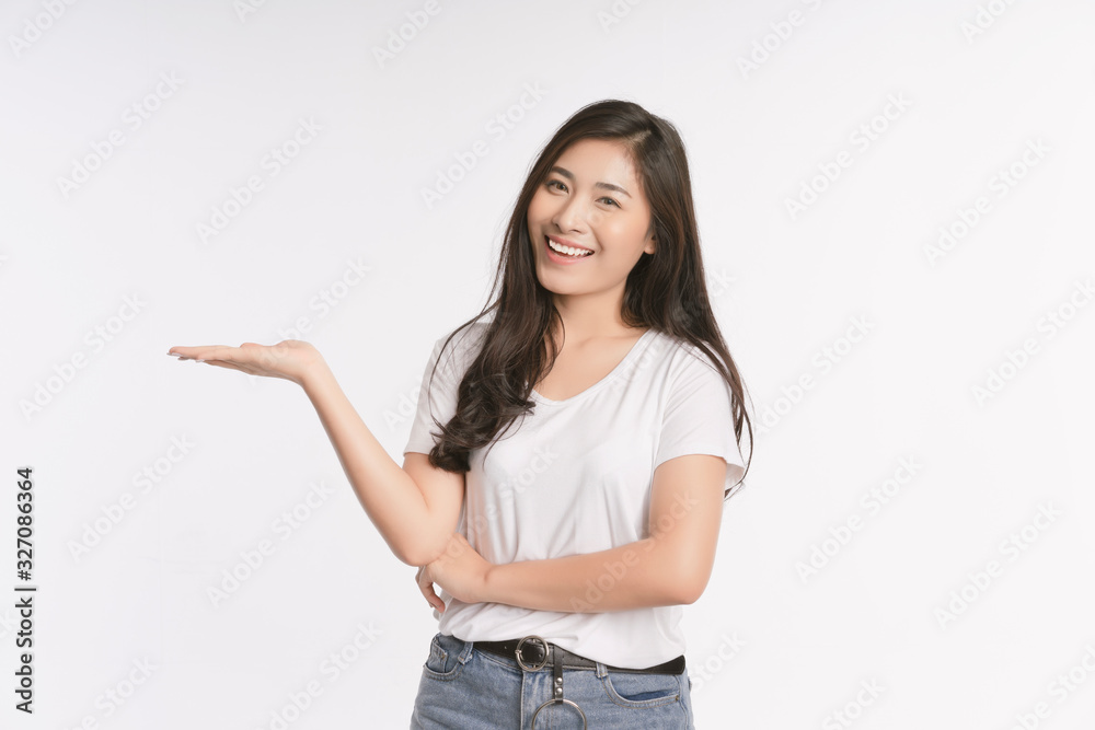 Beauty Asian woman smiles with a charming and shows something to you with healthy skin, teeth and hair isolated on white background, The lady in a summer t-shirt Short jeans. Copy space Beauty Asian woman smiles with a charming and shows something to you with healthy skin, teeth and hair isolated on white background, The lady in a summer t-shirt Short jeans. Copy space