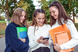 3 girls teenagers, smartphone. Holiday weekend, best friends, emotions happiness fun smile, folders textbooks. Rest school, college study. Happy smiling rejoices. Knowledge, education science.