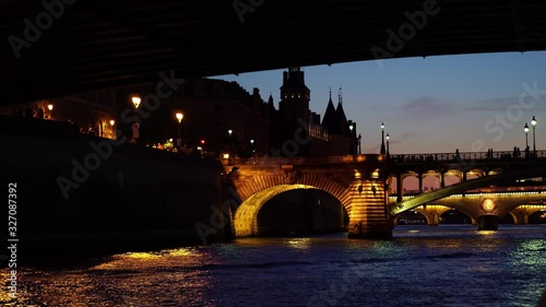 Paris at night, Seine river bridge. Seen from tour sightseeing boat ship. Paris at night. Romantic honeymoon travel destination. Historic landmark. photo