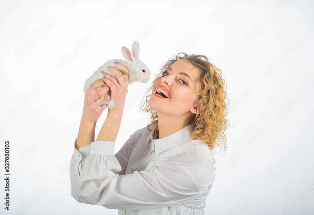 Easter day. Easter Bunny. Happy woman with white rabbit. Girl holds cute little bunny. Beautiful girl kisses white baby rabbit. Easter rabbit. Friendship with Easter Bunny. Cute furry rabbit.