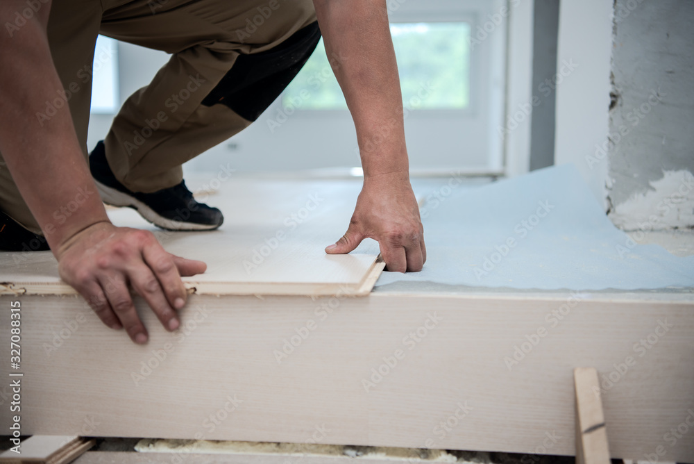 Worker Installing New Laminated Wooden Floor