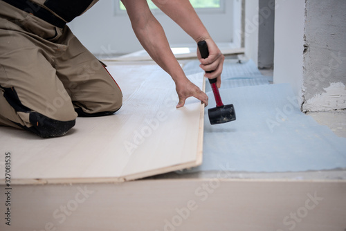 Professional Worker Installing New Laminated Wooden Floor