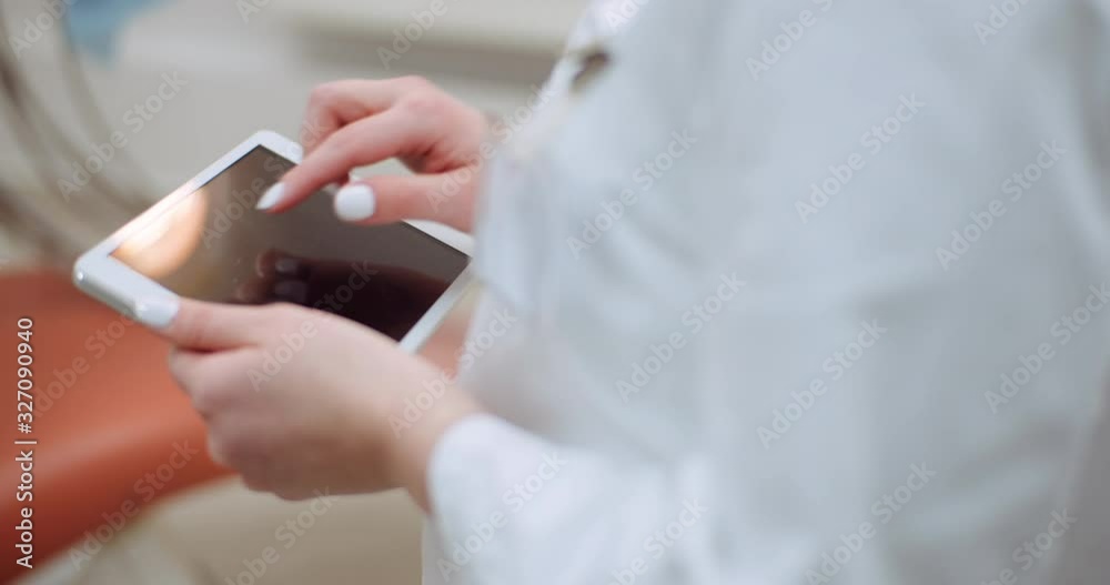 female doctor using digital tablet at dental clinic female doctor using digital tablet at dental clinic