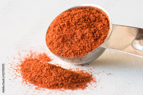 Ground Cayenne Pepper Spilled from a Teaspoon