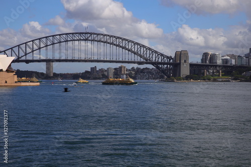 Sydney harbour from the botanical gardens with the harbour bridge and opera house in full view © Elias Bitar