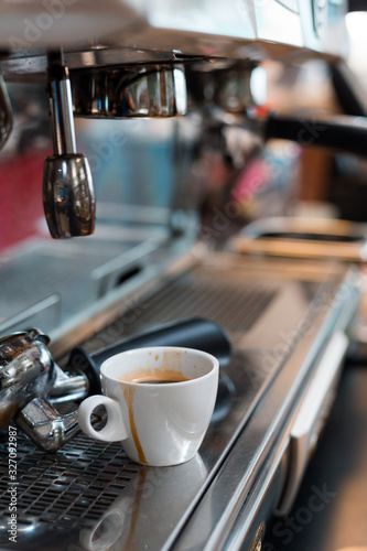 black coffee in white cup on coffee maker