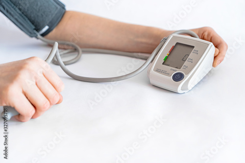 Blood pressure measurement. A woman's hand and a device for measuring pressure. 