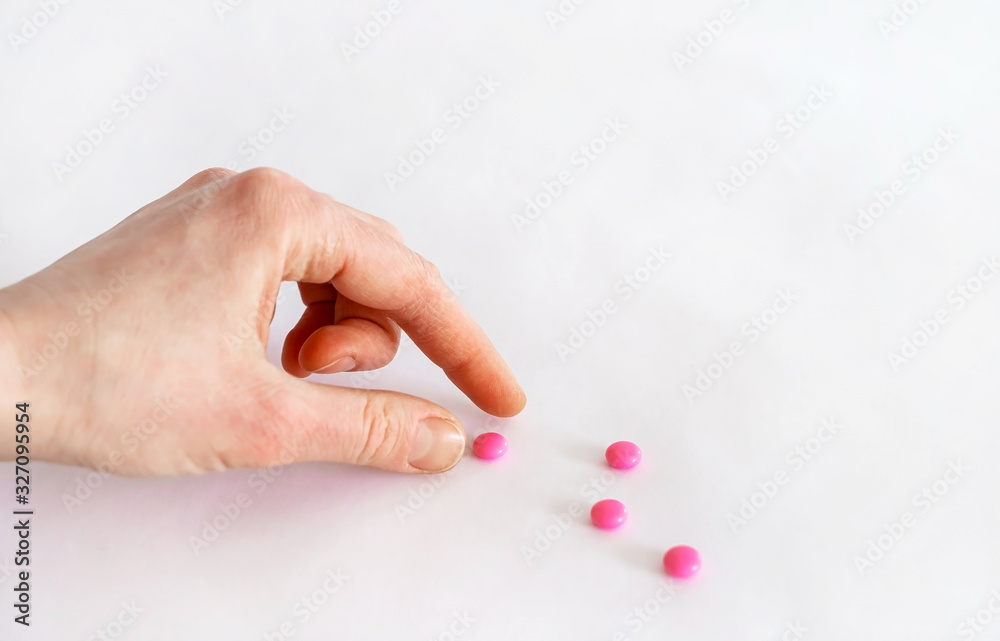 Tablets in hand on a white background close-up. Tablets in hand on a white background close-up.