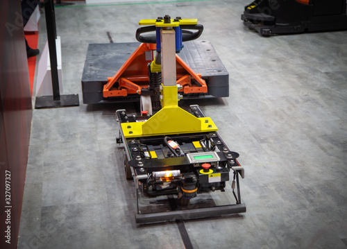Forked Automated Guided Vehicles (AGV) handling material in warehouse photo