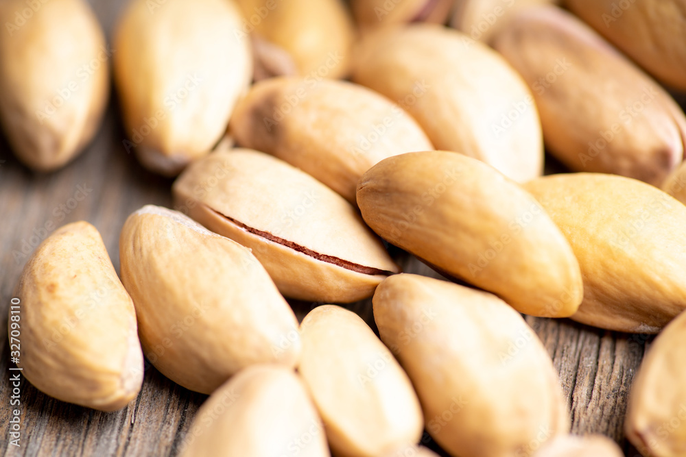 Pistachios in shell on the black rustic background. Selective focus. Shallow depth of field. Pistachios in shell on the black rustic background. Selective focus. Shallow depth of field.