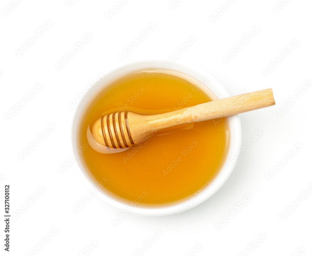 Honey in a white bowl and dipper isolated on white background. Honey in a white bowl and dipper isolated on white background.