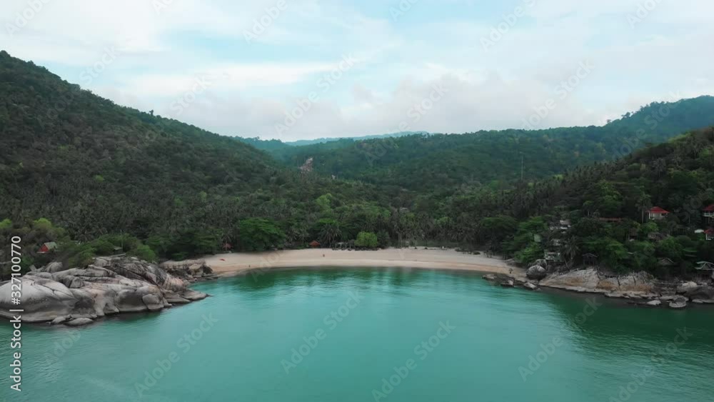 Aerial view of scenery beach. Travel to wild jungles of Thailand. Sea waves leak white sand. Palm trees pass below the drone Aerial view of scenery beach. Travel to wild jungles of Thailand. Sea waves leak white sand. Palm trees pass below the drone