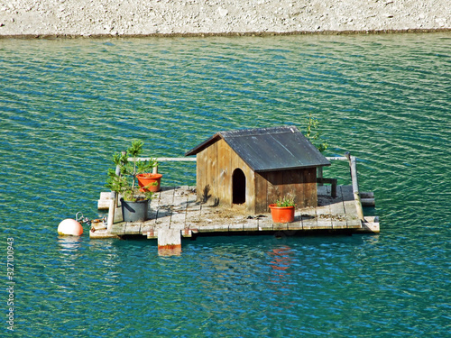 A small duck lodge on a artifical lake Gänglesee (Ganglesee or Gaenglesee) and in the Saminatal alpine valley - Steg, Liechtenstein photo