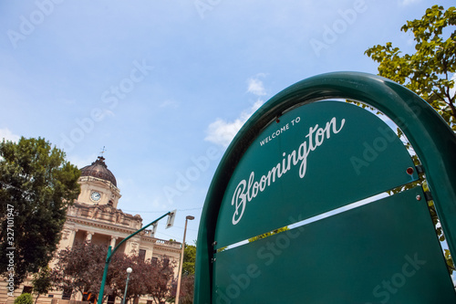Welcome to Bloomington Indiana sign with downtown courthouse in the background photo