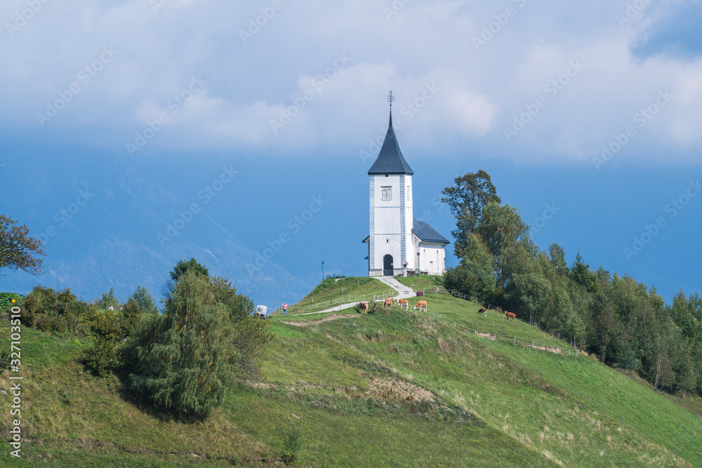 Aerial view of a white church on the mountain top, The Church Of St Primoz in Slovenia