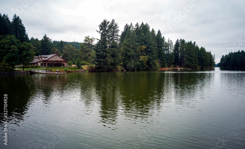 Wonderful Lacamas Lake on a breezy cloudy morning with the wilderness reflecting in the calm shimmering water in Camas Washington