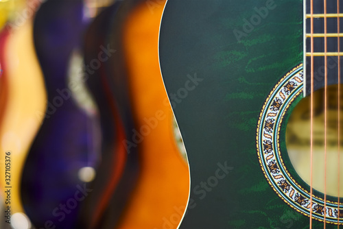 Row of classic acoustic guitars in the shop