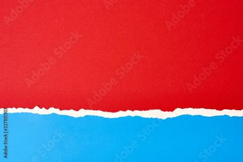 Torn ripped paper edge with a copy space, red and blue color background © Lazy_Bear