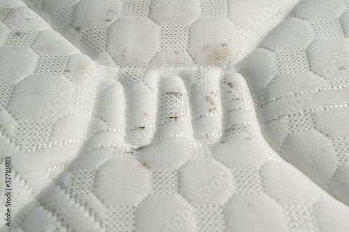 Moisture causes mold growing on the fabric of a mattress.