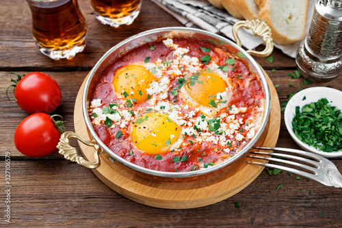 Shakshuka (menemen) fried eggs in tomato sauce for turkish breakfast.