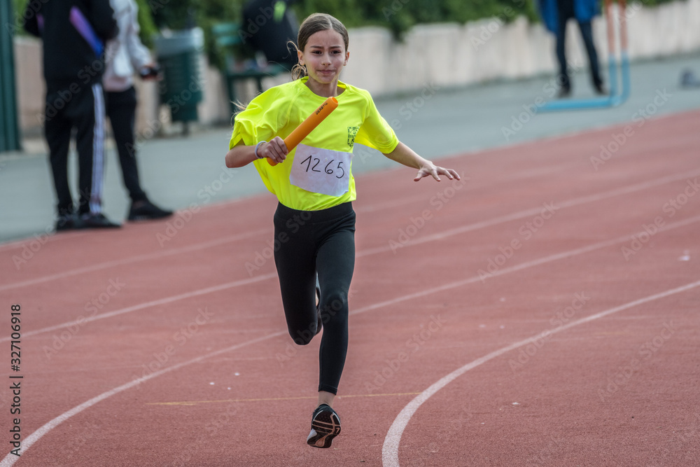 Obraz premium Isolated eleven year old girl in a track and field relay race- Israel