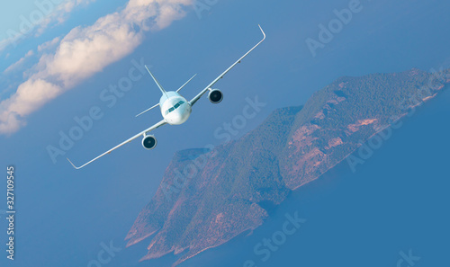 Fototapeta Naklejka Na Ścianę i Meble -  Airplane fly above beautiful island - White passenger airplane in the clouds - Travel by air transport