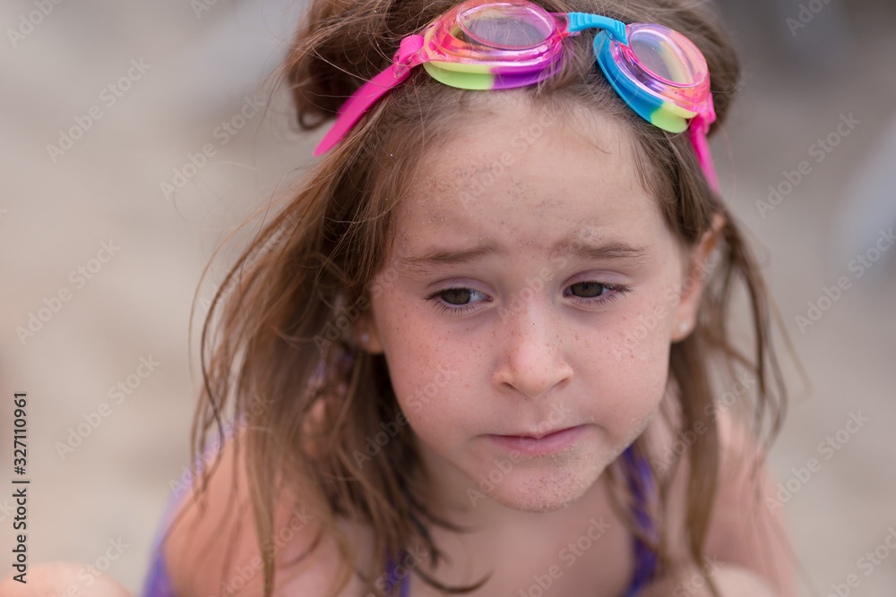 A girl is playing in the sand at a California beach. A girl is playing in the sand at a California beach.