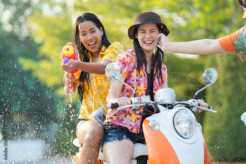 Fotografie Asian people play songkran festival in the summer april They ride motorcycles