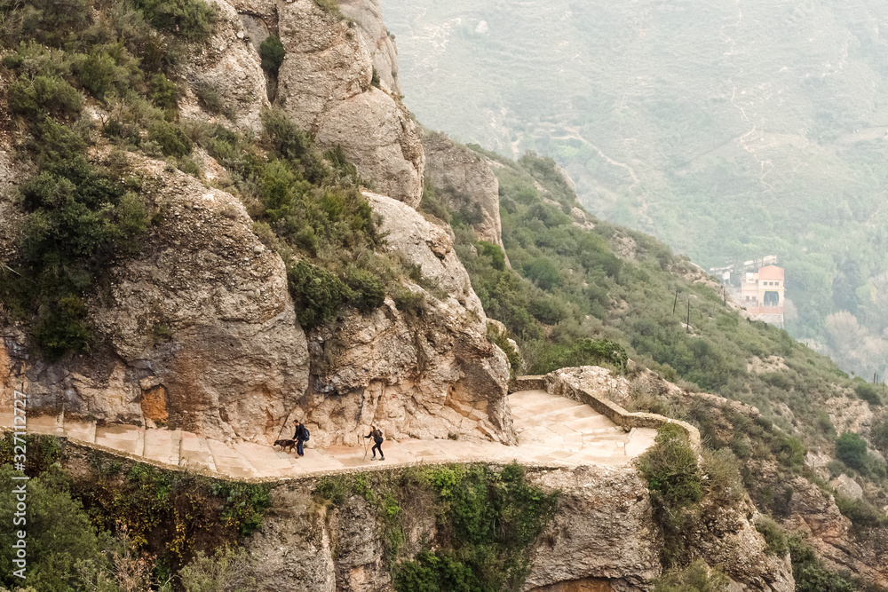 Aerial view of hiking family with dog on Montserrat Mountains
