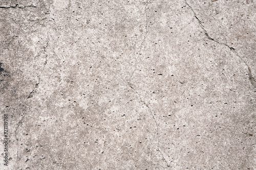 Close up shot of grey stone surface with cracks and potholes. Natural Wallpaper, Texture, Pattern, Backgrounds.