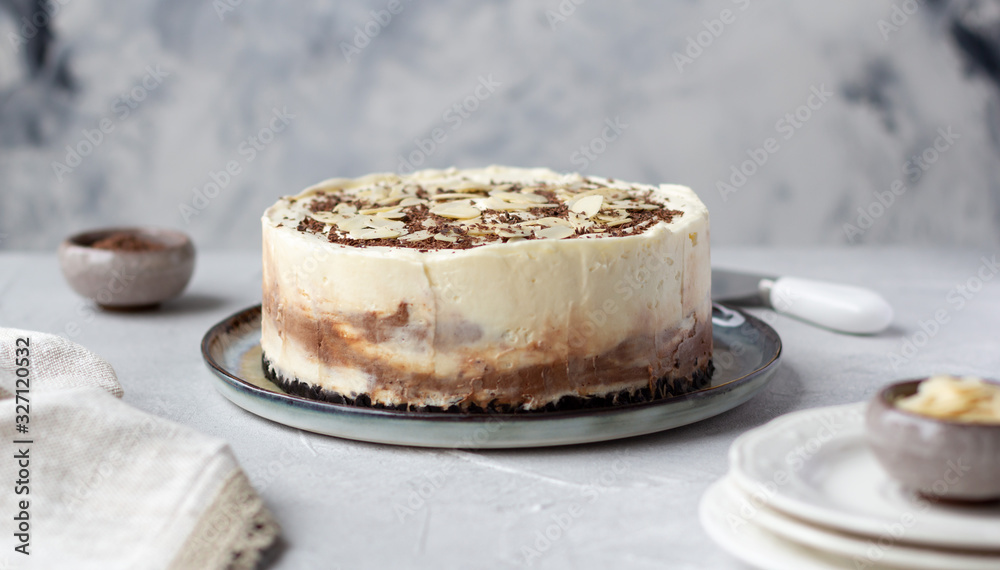 Homemade raw chocolate cheesecake or mousse cake decorated with chocolate morsels and almond flakes. Homemade raw chocolate cheesecake or mousse cake decorated with chocolate morsels and almond flakes.