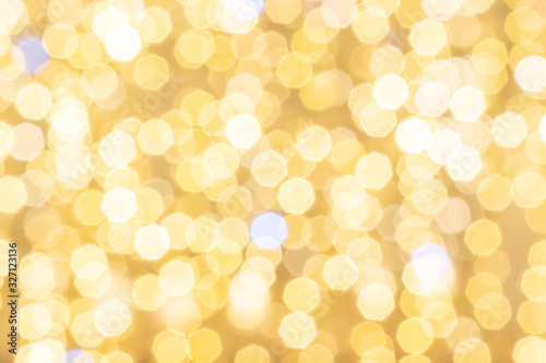Bokeh background gold glitter abstract lights. Festive blur. Defocused winter backdrop.