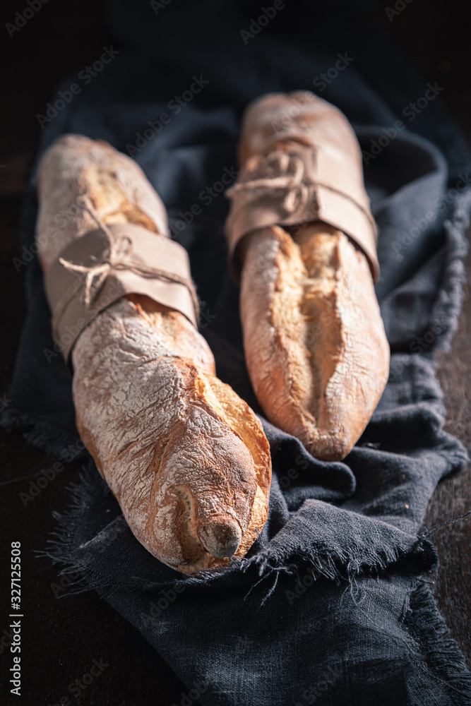 Closeup of french baguettes on dark table Closeup of french baguettes on dark table