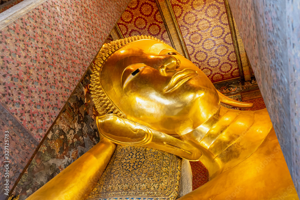 The Reclining Buddha of the reign of King Rama III. This is the largest and most beautiful piece of fine arts of a Buddha image in a reclining position found in Wat Pho, Bangkok, Thailand
