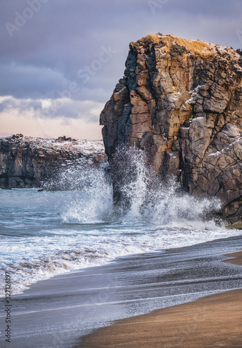 waves beat against rocks on the beach of the Atlantic Ocean in Iceland